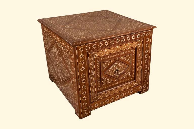 Incredibly detailed camel bone inlay teak chest....also great as a side or coffee table.  Door opens on one side and inlay is on all four sides as well as the top.  The hand work involved in this is magnificent as the pieces are small and intricate