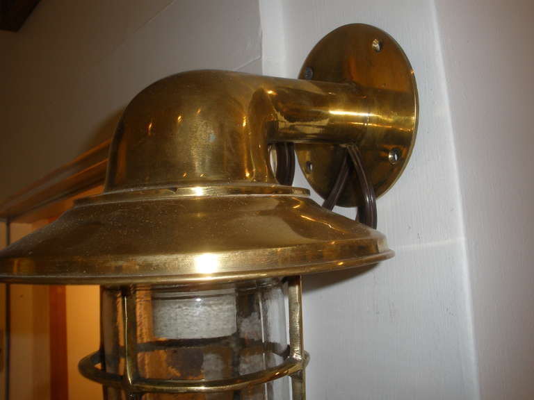 Pair of brass passageway lights from a 1960's merchant ship.  Brass cage and glass unscrew to get to the bulb.  The width of the protective 