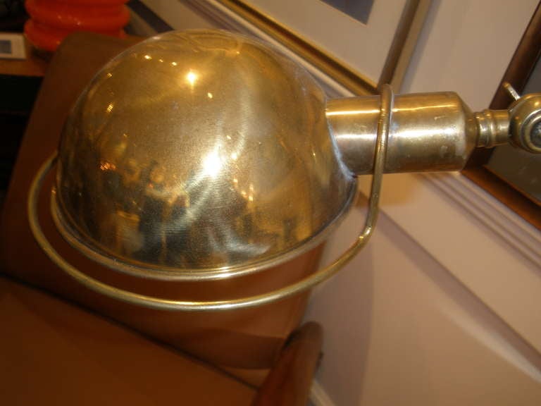 Brass ship's desk lamp with dual adjustability....for the arm and the shade.  This takes a European E-14 bulb (which are easily found) and has been rewired for American use.  The depth measurement is the base diameter.  The diameter of the shade is