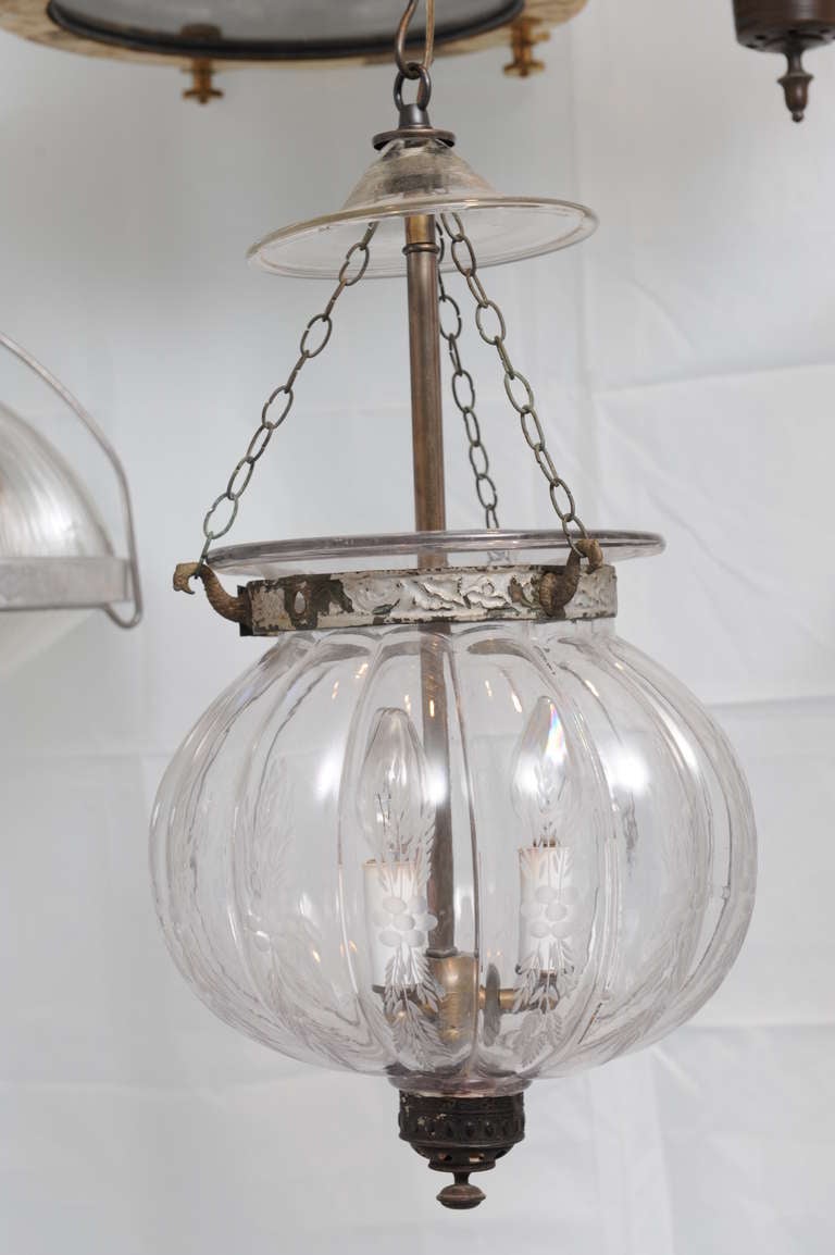 Pair of hand blown etched melon hall lanterns with wheat etching along the ribs, late 19th c. with smoke cap as they were originally used with candles.  Embossed brass hardware.  Electrified for modern use with 3 candelabra bulbs.  Classic and