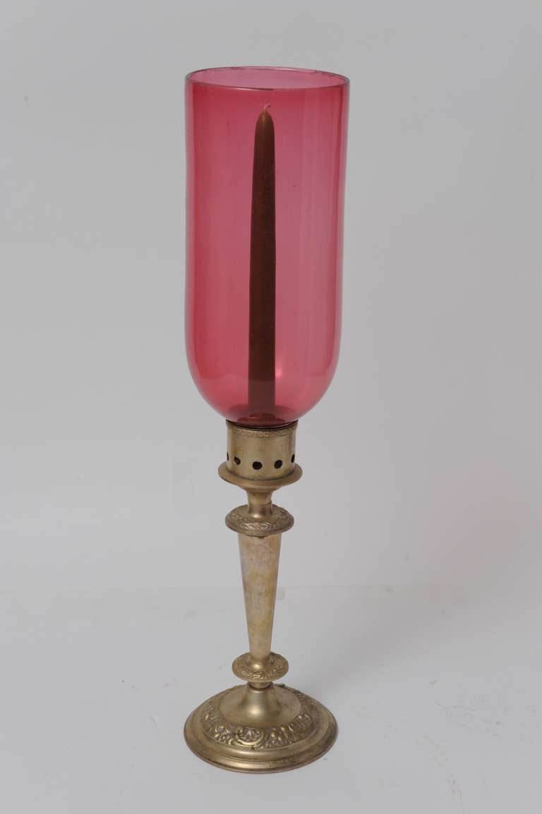 Pair of rare cranberry, handblown hurricane shades on silver plated candlesticks, late 19th century English. Measure: Height of just the shade is 10 inches.