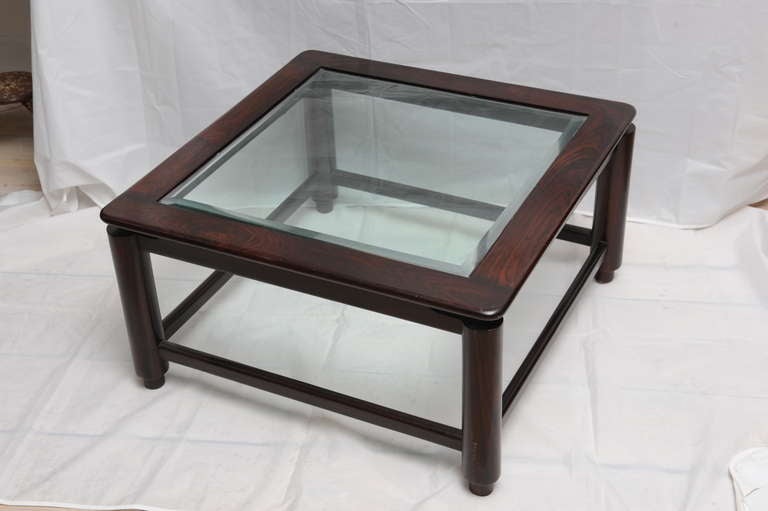 British Colonial rosewood coffee table with bevelled glass from the 1960s. Beautifully constructed, simple and elegant.