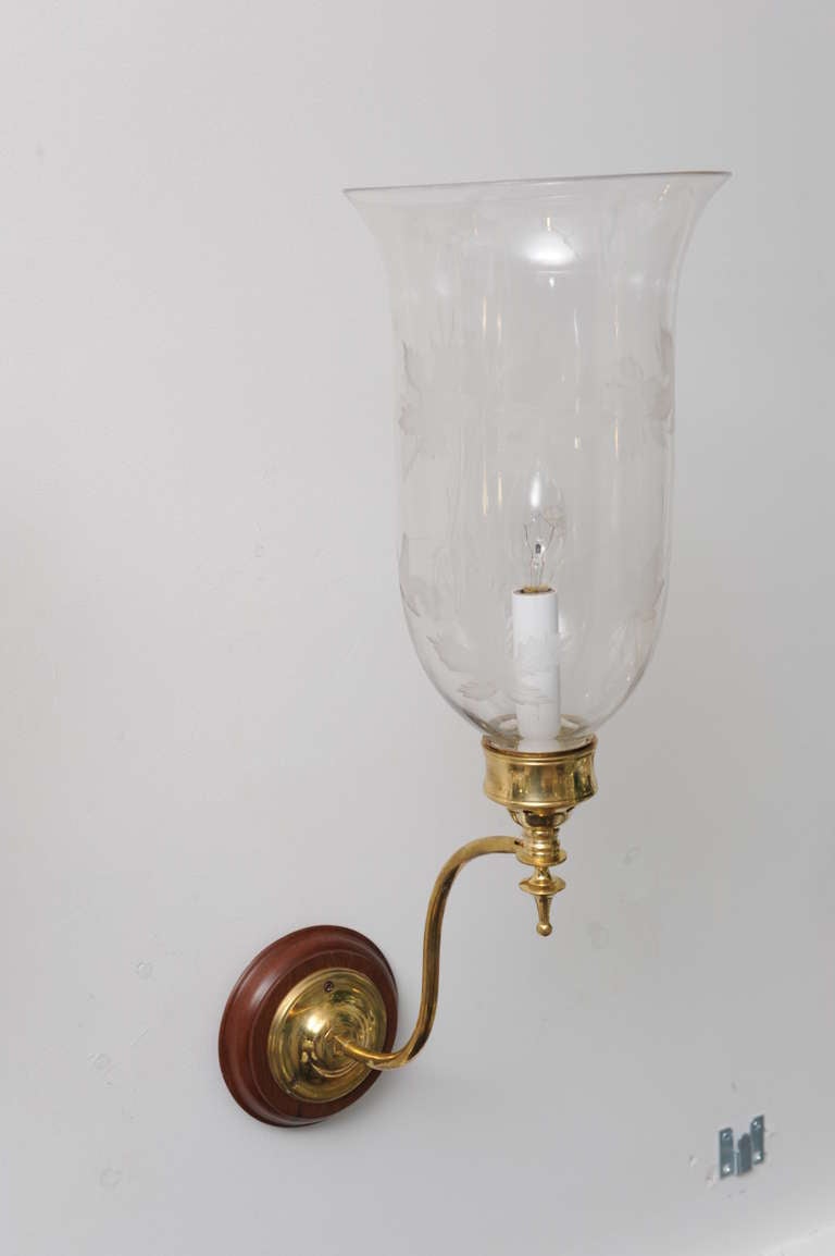 Pair of late 19th C. hand blown hurricane shades with oak leaf etching and a fluted top.  The classic brass sconce arms are more recent, mounted on mahogany back plates.  These have been electrified for modern use and take a candelabra size