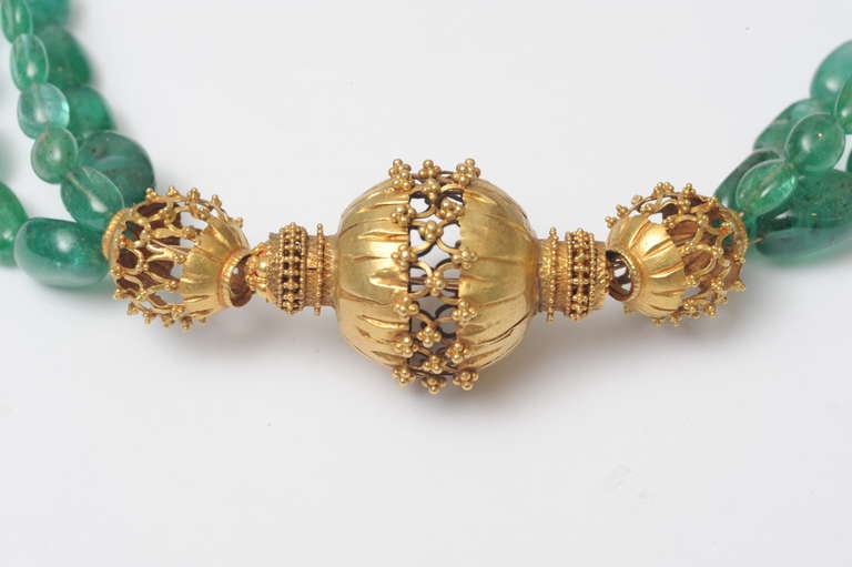 A fine and beautiful three strand tumbled Columbian emerald necklace with old 22-karat gold Indian beads of magnificent workmanship. Truly one of a kind.

Fine Indian Gold Jewelry, located on Nantucket Island.