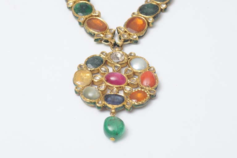 This is an incredible and beautiful necklace connected to the Indian mythology of the NavaRatna.  Made of 22K gold with precious and semi precious gemstones in a Kundan setting with extraordinary enamel work on the reverse side.  Dating to the early