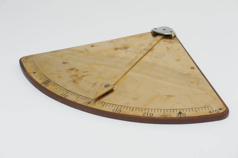 A brass and chrome clinometer mounted on a wooden back plate.  Used on ships to measure the degree of healing.  Mid-century, European

Shop located on Nantucket Island
Nautical Antiques and Marine Artifacts