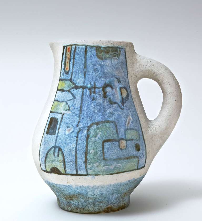 A unique and decorative pitcher in grogged clay, white and cloudy blue slip, decorated with abstract and coloured designs, displays wonderfully. 
A dynamic touch of orange glaze inside the piece. 

Signed by the french artists :  2 Potiers