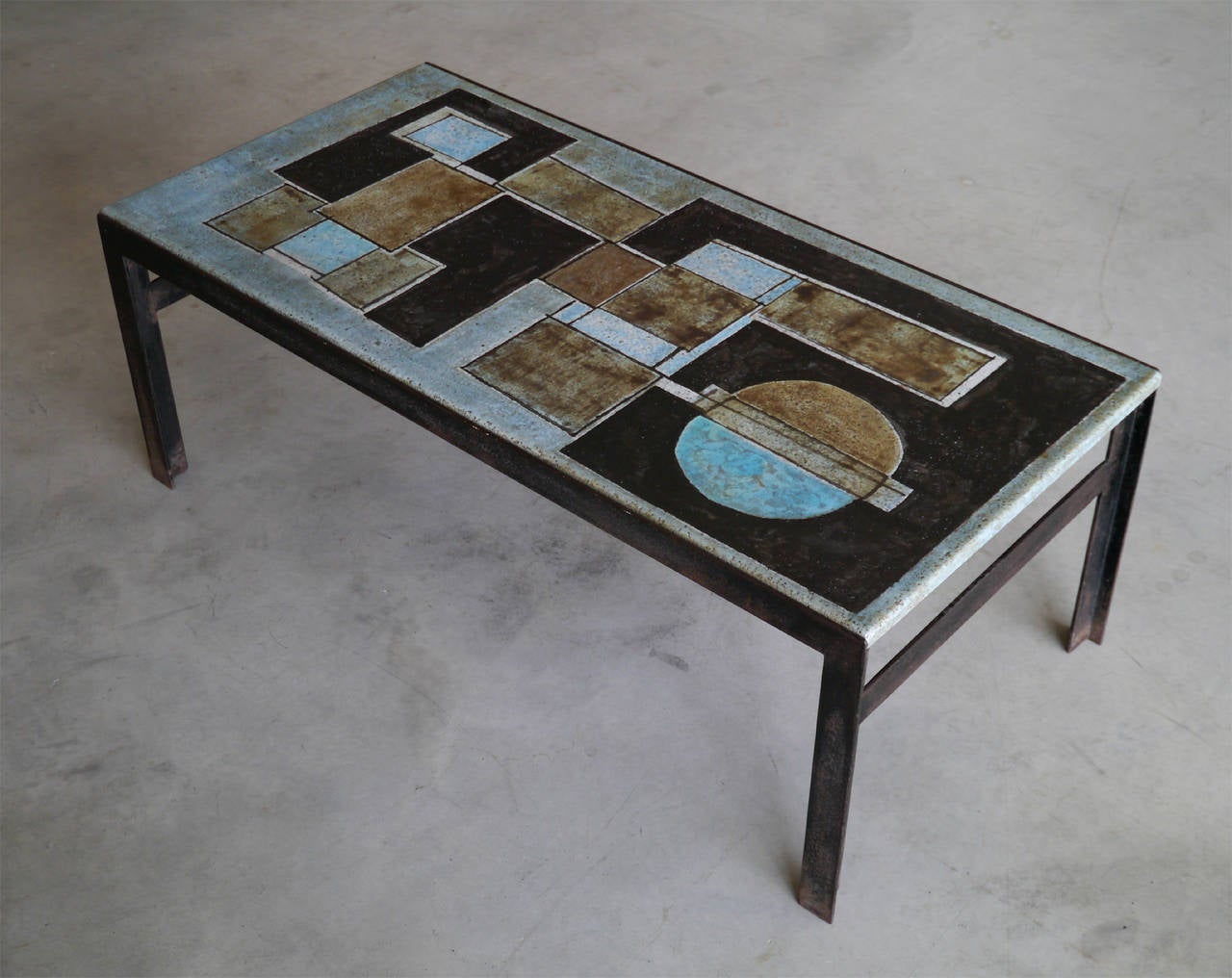 A very rare rectangular table consisted with an exceptional single panel of lava glazed mounted on its elegant and original metal frame.

Signed by the Artists.