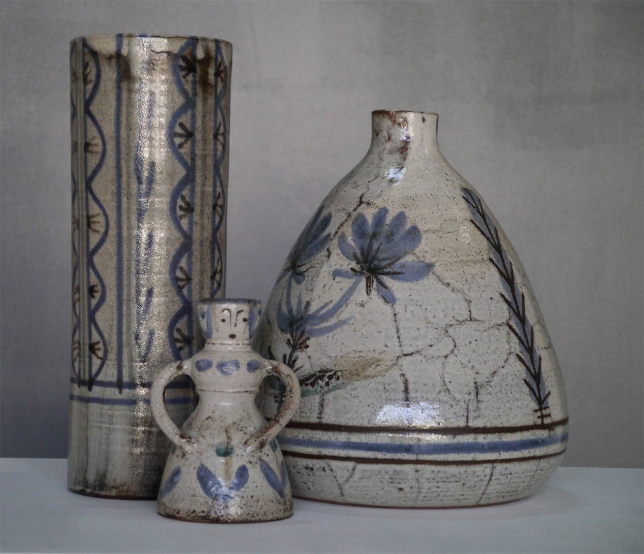 A wonderful grouping of two lamp bases and a cylinder-shaped vase.

Gustave Reynaud founded his Vallauris worshop in 1955 and often worked in close collaboration with his talented brother-in-law, Jean Derval.

Both density and poetry of these