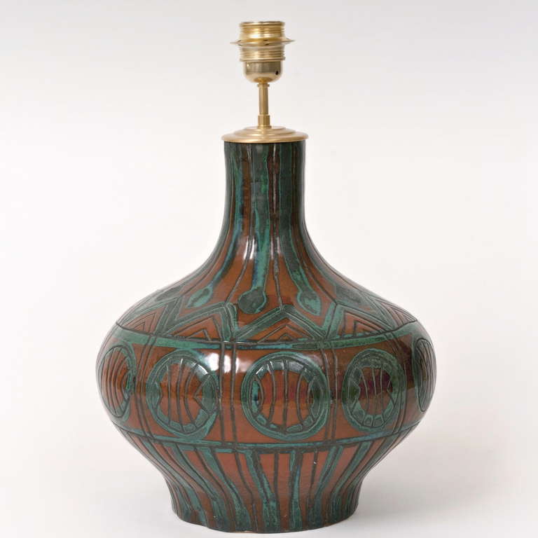Earthenware with a glossy orange and water-green overglaze and incised and stylised decoration. 
Vallauris, circa 1950

For sale without the lamp-shade : allowing optimal packaging and therefore shipping reduction costs.

Height dimension
