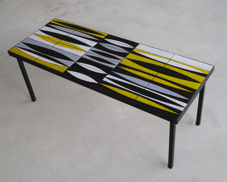 De la gamme iconique des navettes, une merveilleuse réalisation dans un mélange de couleurs inattendu.

Carreaux de céramique martelés noirs avec des dessins rythmiques réalisés en émaux blancs, gris et jaune vibrant brillant avec la technique de