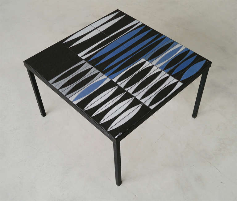 An iconic pattern mounted in an original squared shape.

Black hammered ceramic tiles with rythmic drawings realized in white, grey and shiny vibrating blue glazes with paraffin's technic.
 
It wears the artist's signature. 

The black satin