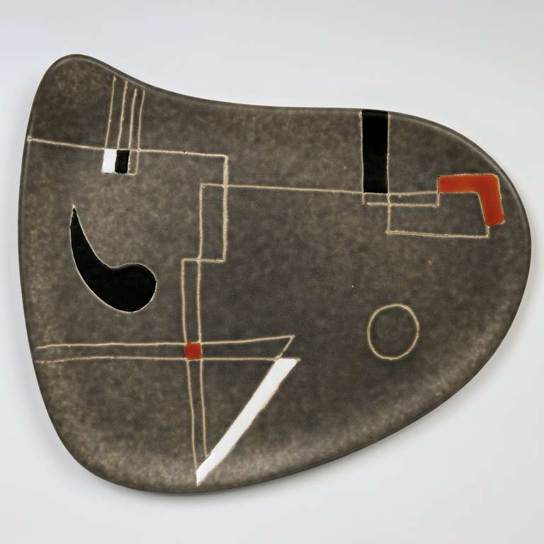 Large ceramic dish, glazed in cloudy grey with and abstract and geometric decoration engraved and over-glazed.
Reminiscent of Alexander Calder or Joan Miró art works. 

The design of each decoration over-glazed was unique. 
Signed back
