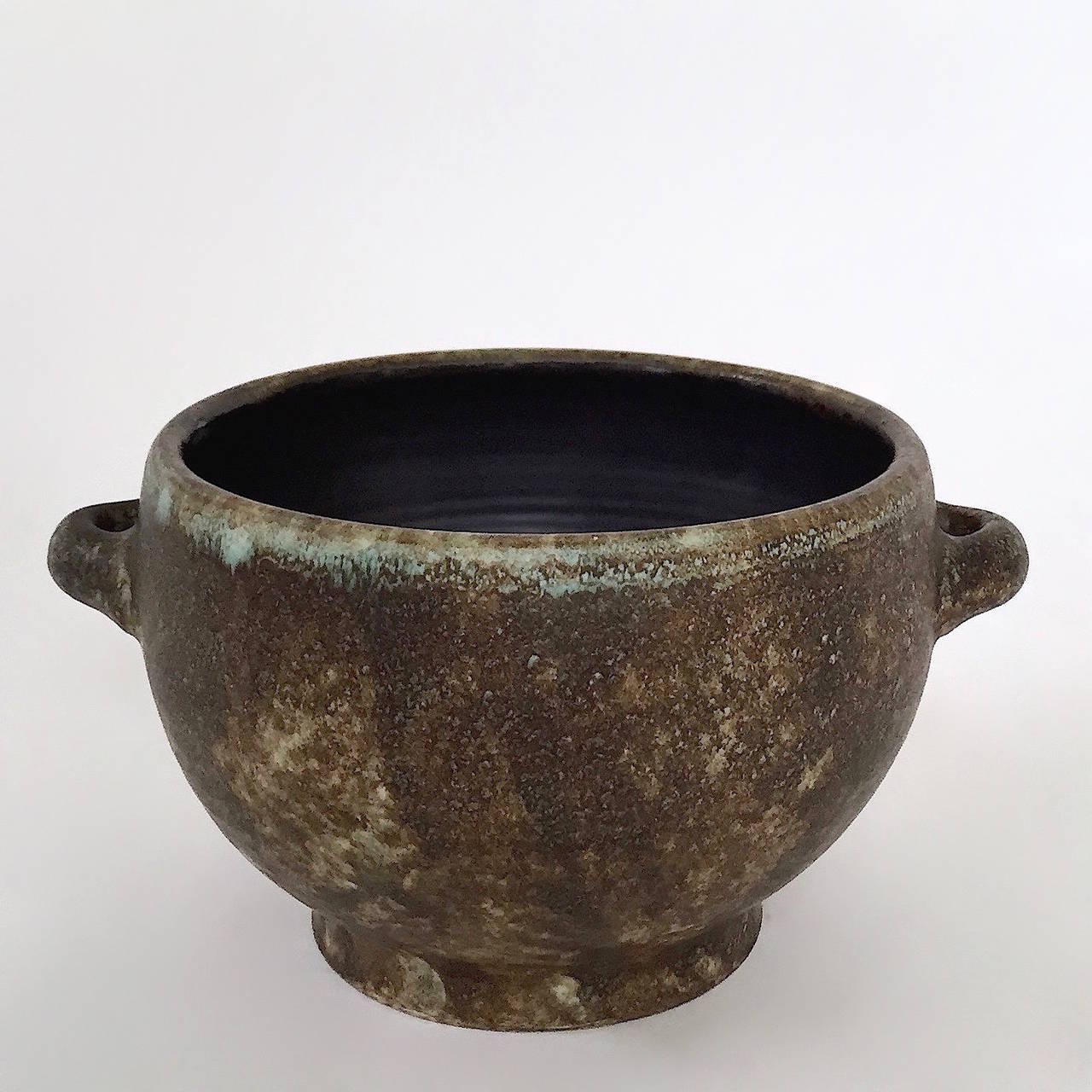 Ceramic Pot with cover, earthenware glazed in cloudy brown tons with touches of blue, and with shiny black glaze inside the pottery piece. 

The piece is signed 2 Potiers (deux potiers), engraved on the bottom