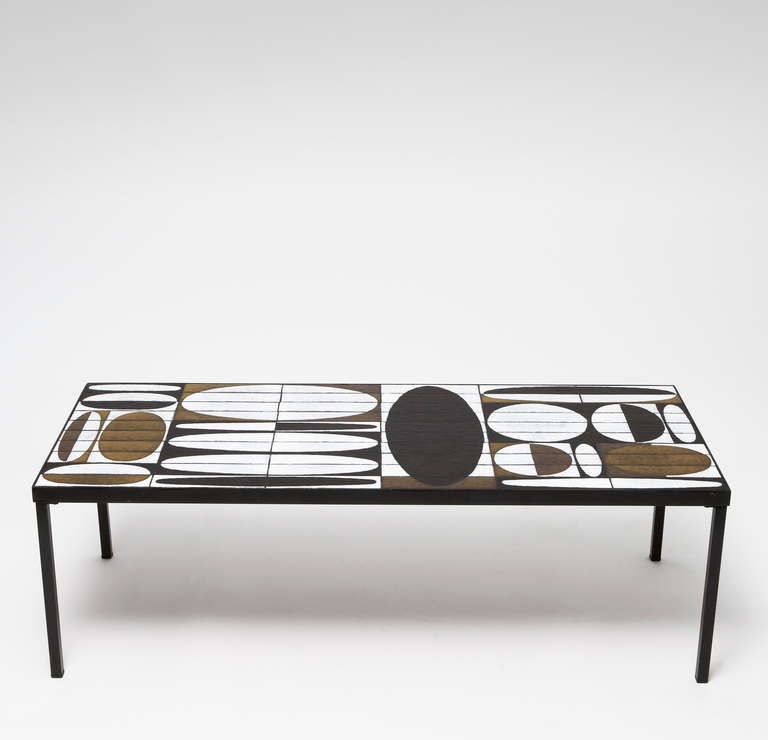 Large rectangular coffee table with a glazed ceramic tiles top on black enameled metal frame. 
Tiles glazed in various shades of matt and shiny brown, black, and white composing a beautiful geometric and abstract decoration of « navettes » and «