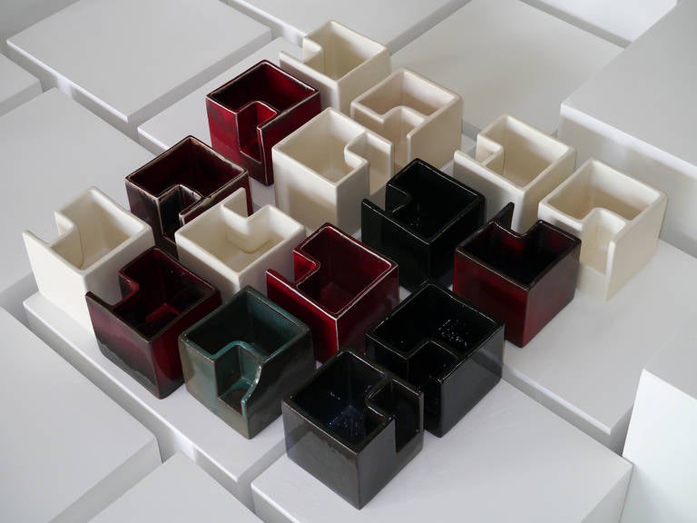 A group of 16 ceramic boxes forming a stylized labyrinth. 

Manganese earth with Japanese inspired glazes and white clay with matte finish white glaze. 

Each wears the signature of the artist, some differs depending the date of