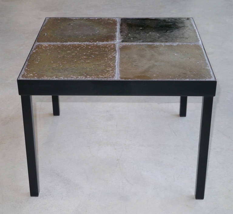 Four thick Italian glazed lava tiles with an iridescent metallic luster mounted on a 
contemporary black metal structure.

Four similar tables are available.