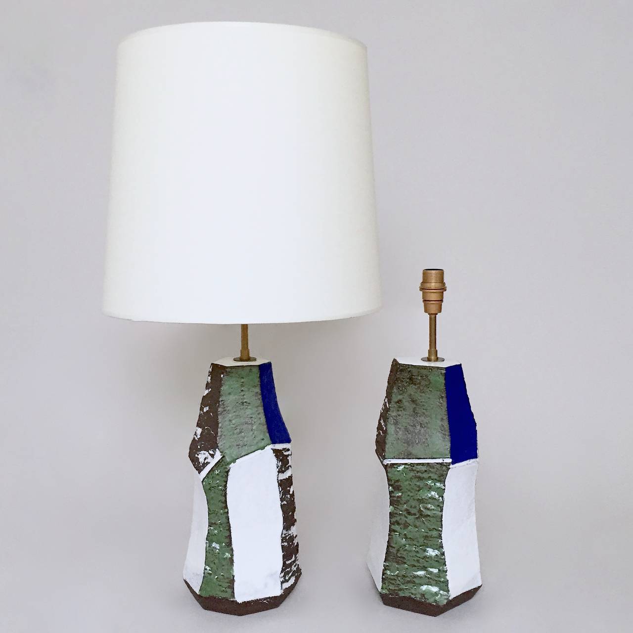 Faceted pair of lamp-bases, stoneware glazed in green, white, blue and matt dark brown.

Uniques pieces hand-sculpted by the french ceramicist : tribute to Serge Poliakoff artwork.

The dimensions approx. are for the ceramic pieces solely :