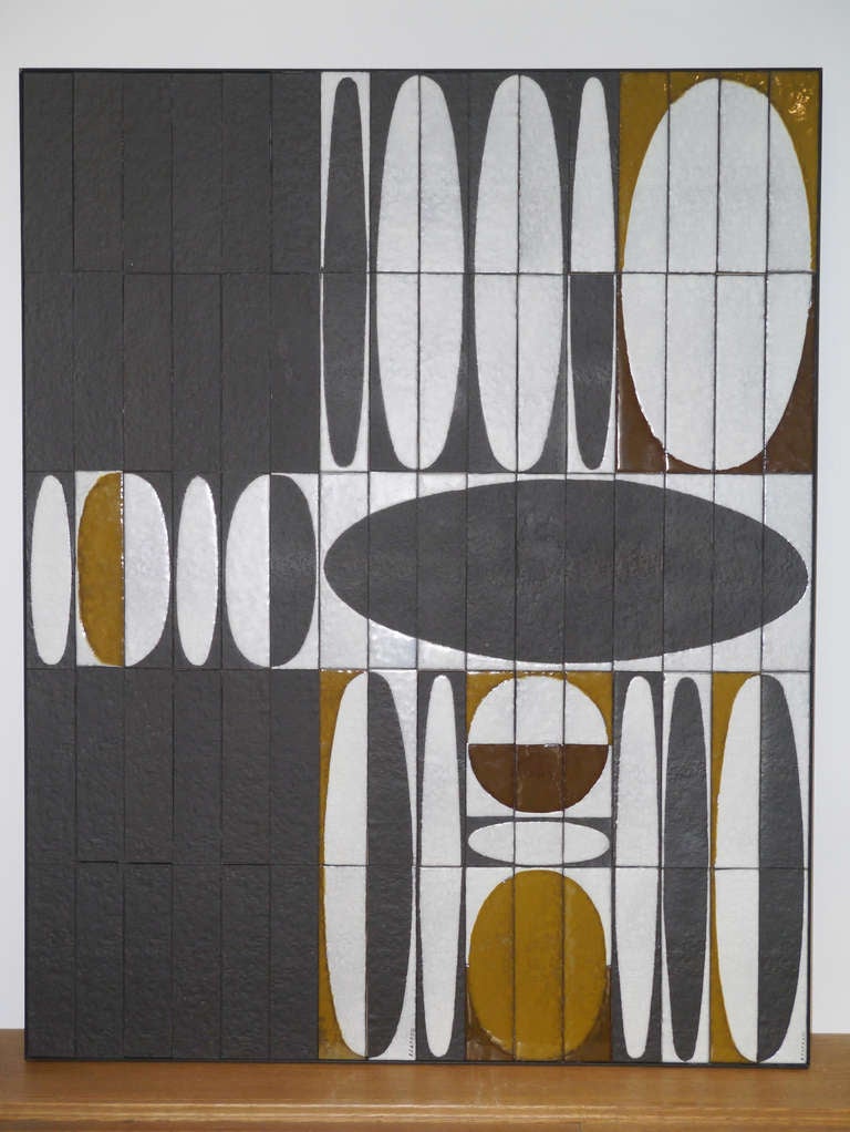 The so iconic "Ellipses" motive realized with paraffin technic in white and two shades of brown shiny glazes on hammered black tiles.

Formely realized to show the pattern in Roger Capron's workshop the panel wears two signatures.
It has