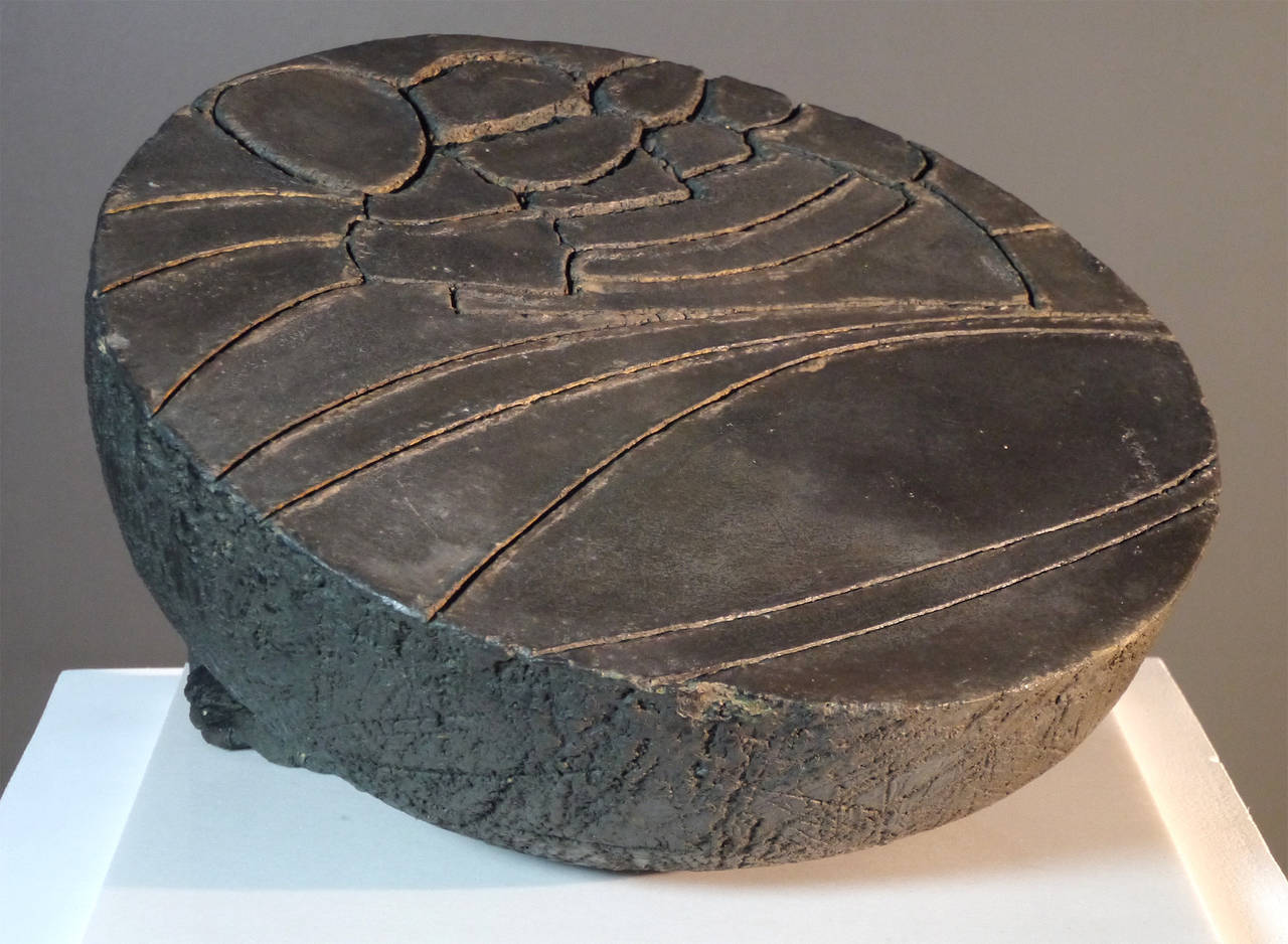 Oxides on carved stoneware.

This amazing piece was part of the selection of the Mostra of Contemporary Art in Bologna in 1988.

From the north of Spain's mountains, where she worked on oversized blocks during the 1970s in Hecho, to the work of