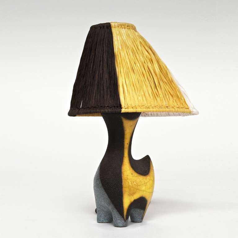 A colorful zoomorphic table lamp : earthenware with gritty black and blue-grey glaze, and glossy yellow crackle-glaze decoration, with genuine raffia lamp shade specially designed for. 
A rare piece by Gilbert Valentin, studio 
