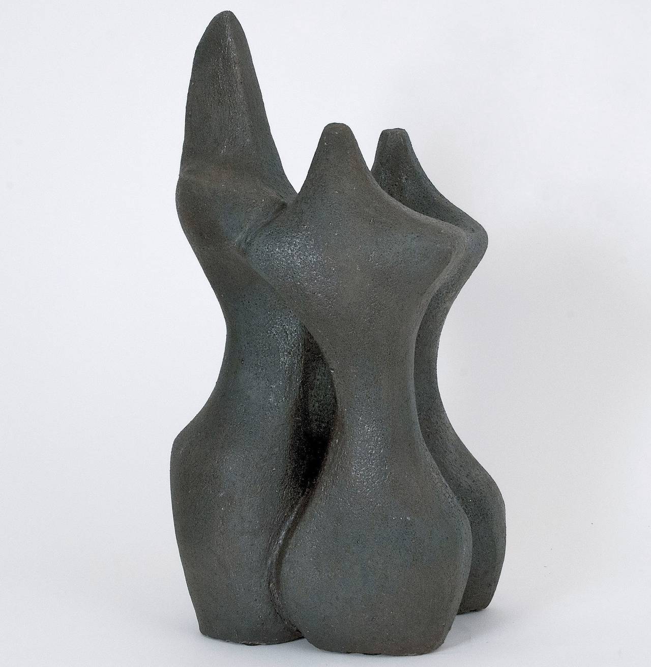 Impressive grogged clay sculpture, glazed in textured warm and dark grey, forming an abstract and biomorphic hugging group. 
A large and heavy piece could be displayed on floor.