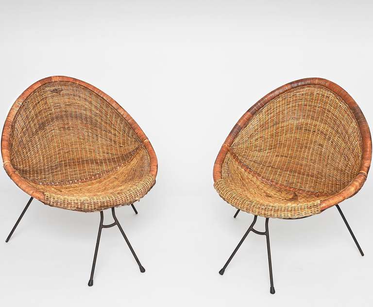 Pair of wicker and bamboo basket chairs, on a black metal frames. 
Probably made in Italy, circa 1950-60. 
Can be used indoors our outdoors. 

Hand woven made models, one of them is a little bit smaller : 
Measurements approx. : 
H 80 cm - D