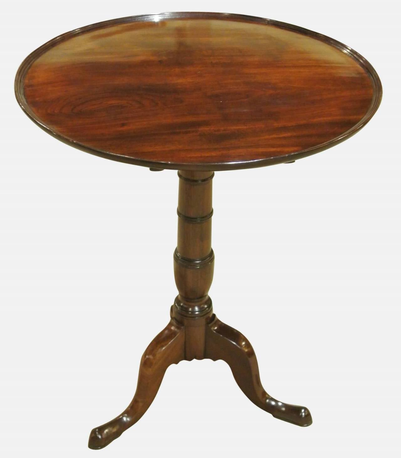 A very fine Georgian mahogany tilting dish top wine table on a turned gun barrel stem with tripod base.