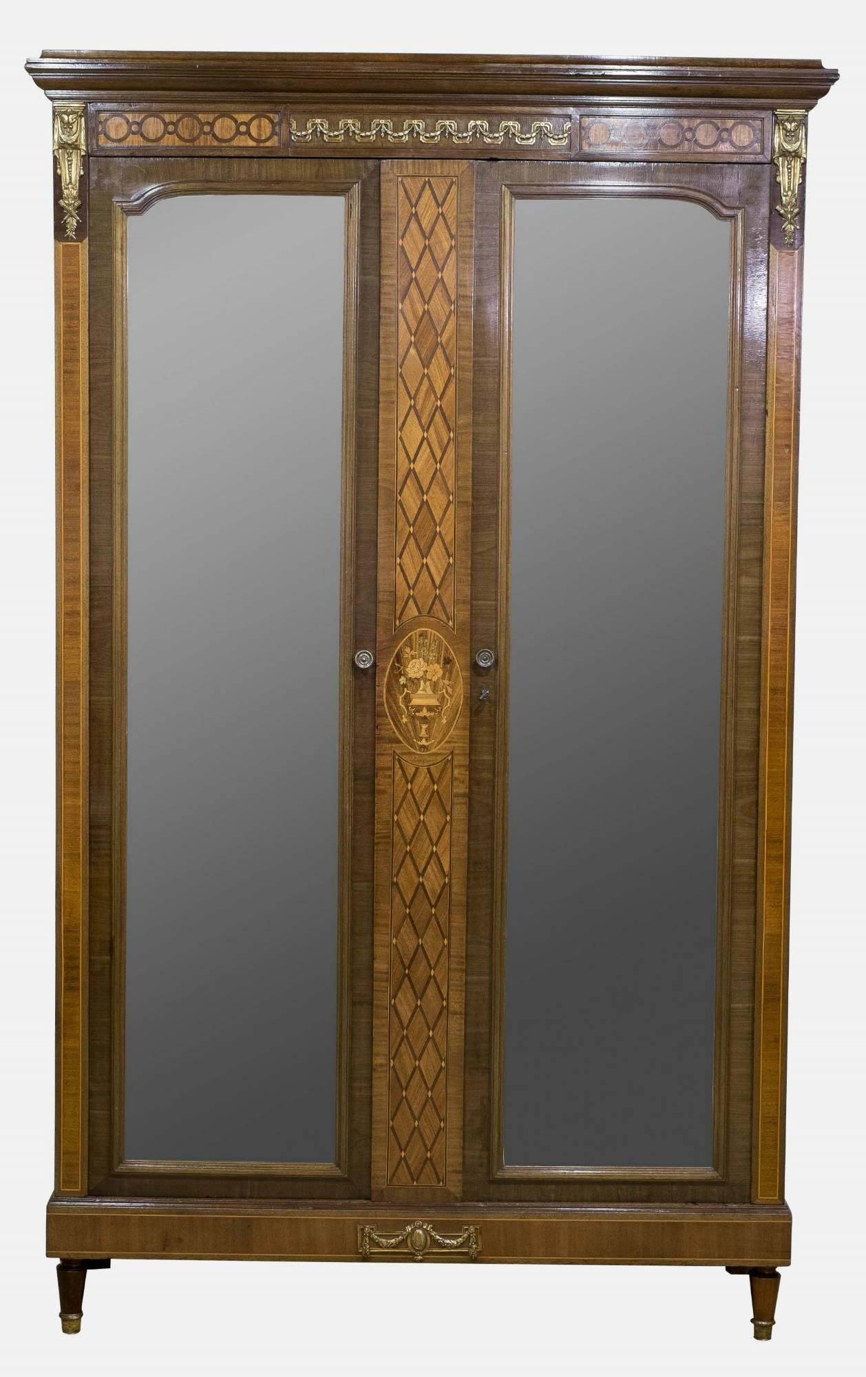 A fine French mahogany and kingwood two-door armoire with boxwood inlay and ormolu mounts.