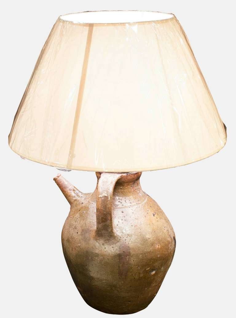 A 17th Century Earthenware pouring jug converted into a table lamp
