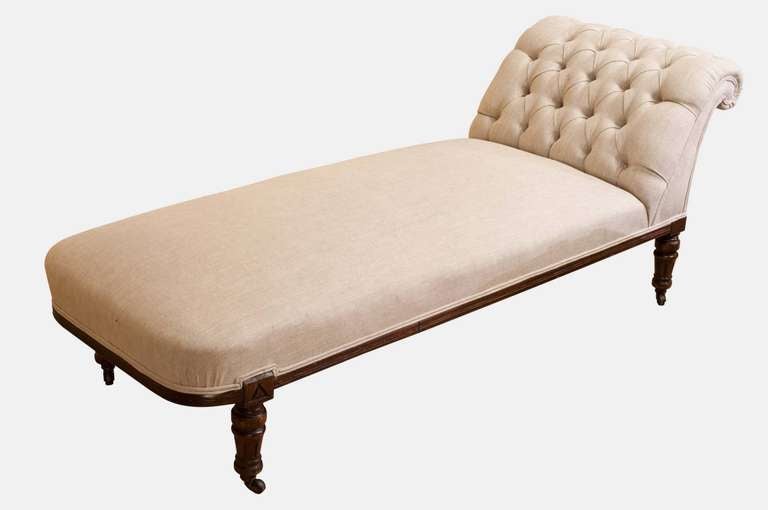 A beautiful late 19th century deep button-backed, carved show wood daybed, skillfully reupholstered in a contemporary linen fabric.