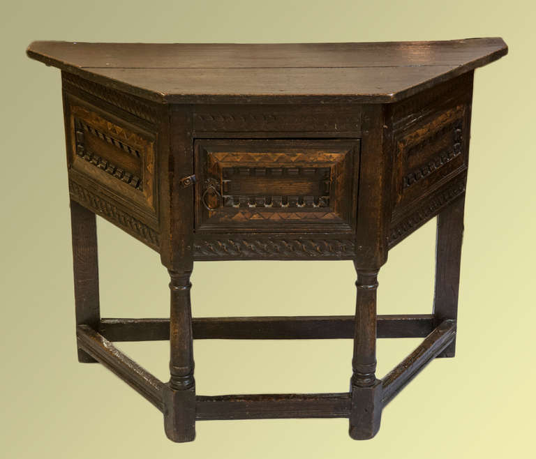 A rare early English oak credence table with carvings and Hollywood and cherrywood decoration.