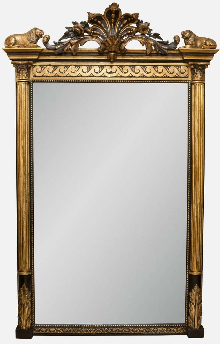 An ornately crested Regency pier mirror with recumbent lions flanked by fluted corinthian columns on acanthus leaf plinths.

Provenance: Violet Hill House, ex residence of Sir Sean Connery