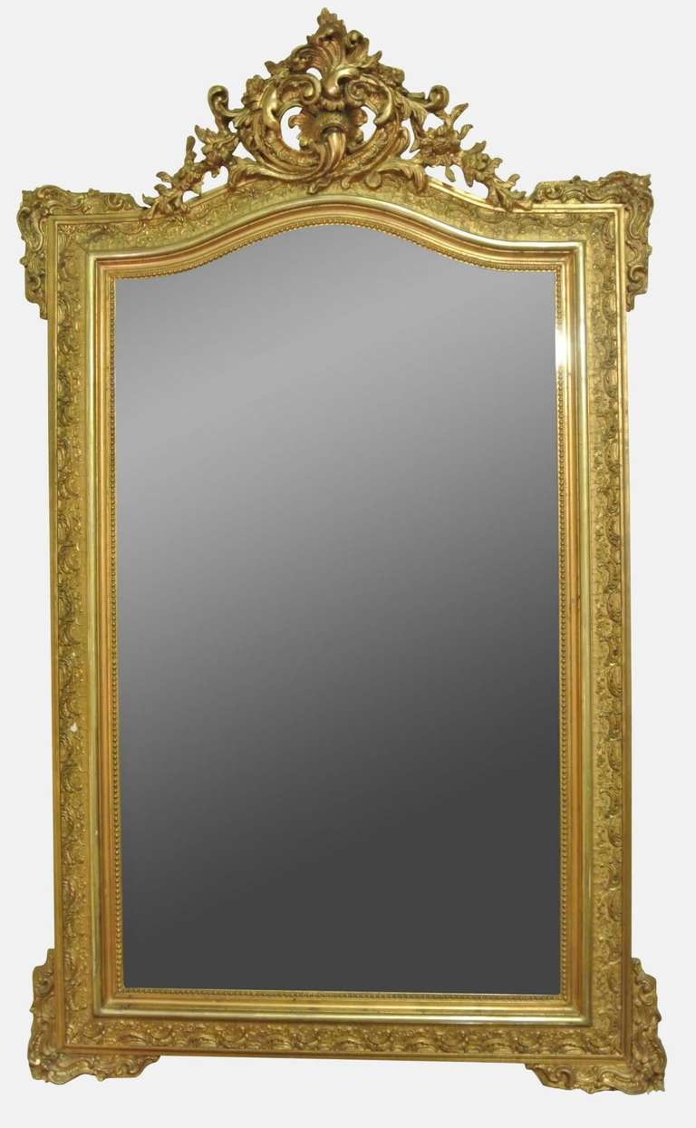 A 19th Century rococo style mirror with scroll crest and moulded corners
