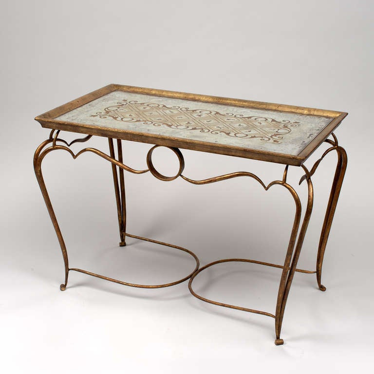 Coffee table in gilt wrought iron 
France circa 1940
Top in reverse painted mirror in a gilt wooden frame