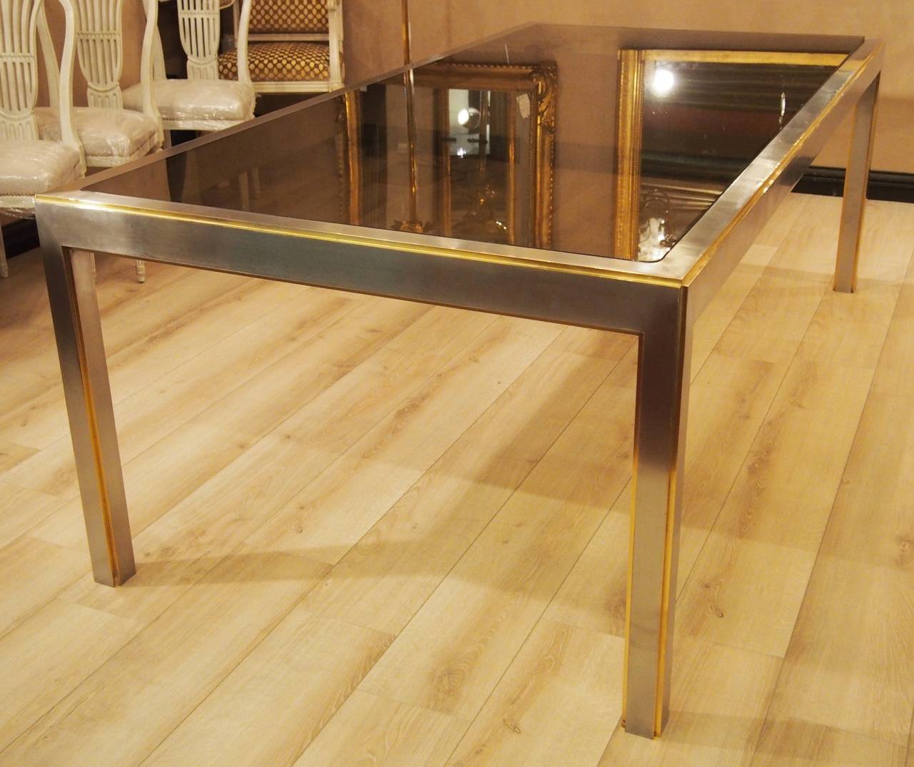 Large dining table, 
unique model made by a French architect,
high quality stainless steel, some details gilded, smoke security glass top.
Marked Saint Gobain.