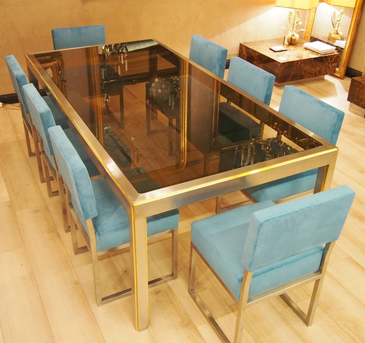 Nice dining room set, 
unique model made on a special order by a French architect in 1965.
The table and the eight chairs
in high quality stainless steel,
security smoke glass, some details gilded,
L 220 cm, W 110 cm, H 75 cm.
The chairs are