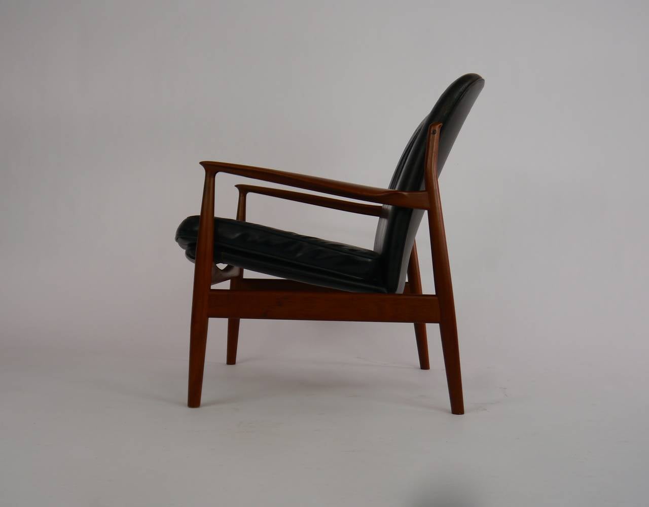 Teak and leather lounge chair by Finn Juhl for France and Daverkosen. This example a rarely seen variant of the more common model 136.