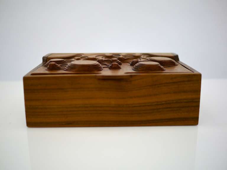 interesting studio made carved box in walnut, top is carved with an undulating design that varies in height.