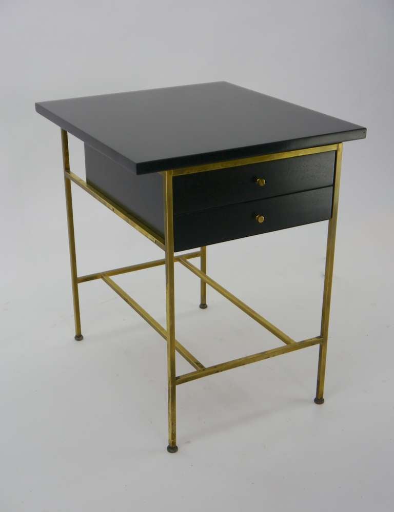 Two-drawer nightstand or end table with brass frame and mahogany case with brass button pulls, mod. no. 8712, by Paul McCobb for Calvin Group, American, circa 1950.