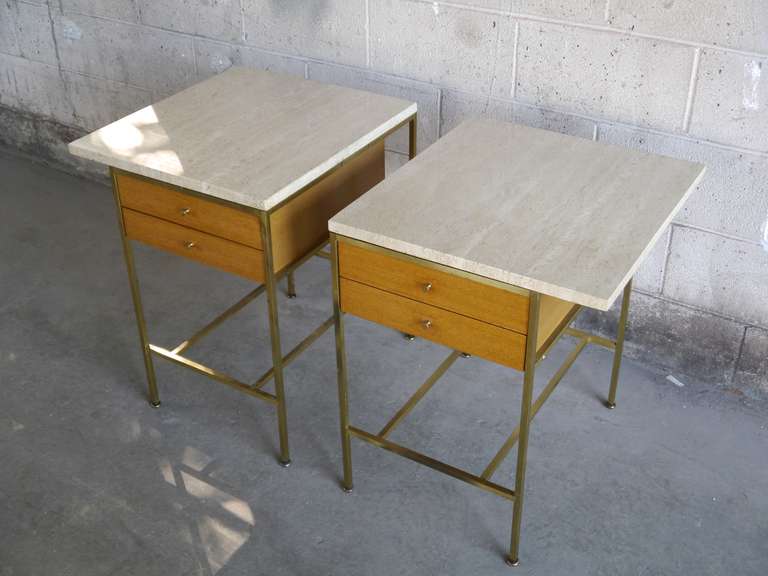 Pair of Paul McCobb Irwin collection nightstands with brass frames, mahogany cases and book matched Travertine tops. Excellent original condition with minor hand wear. Price includes professional refinishing to order. Call or email for