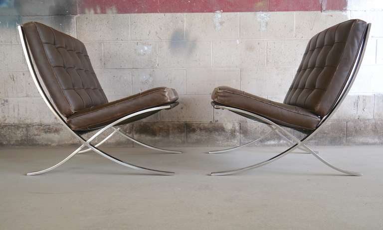 Exceptional pair of Barcelona chairs by Mies Van der Rohe for Knoll. This pair being perfectly worn but lacking any damage. The Art Metal / Knoll label dates them to the early 60's The foam in all four cushions has been professionally redone. Far