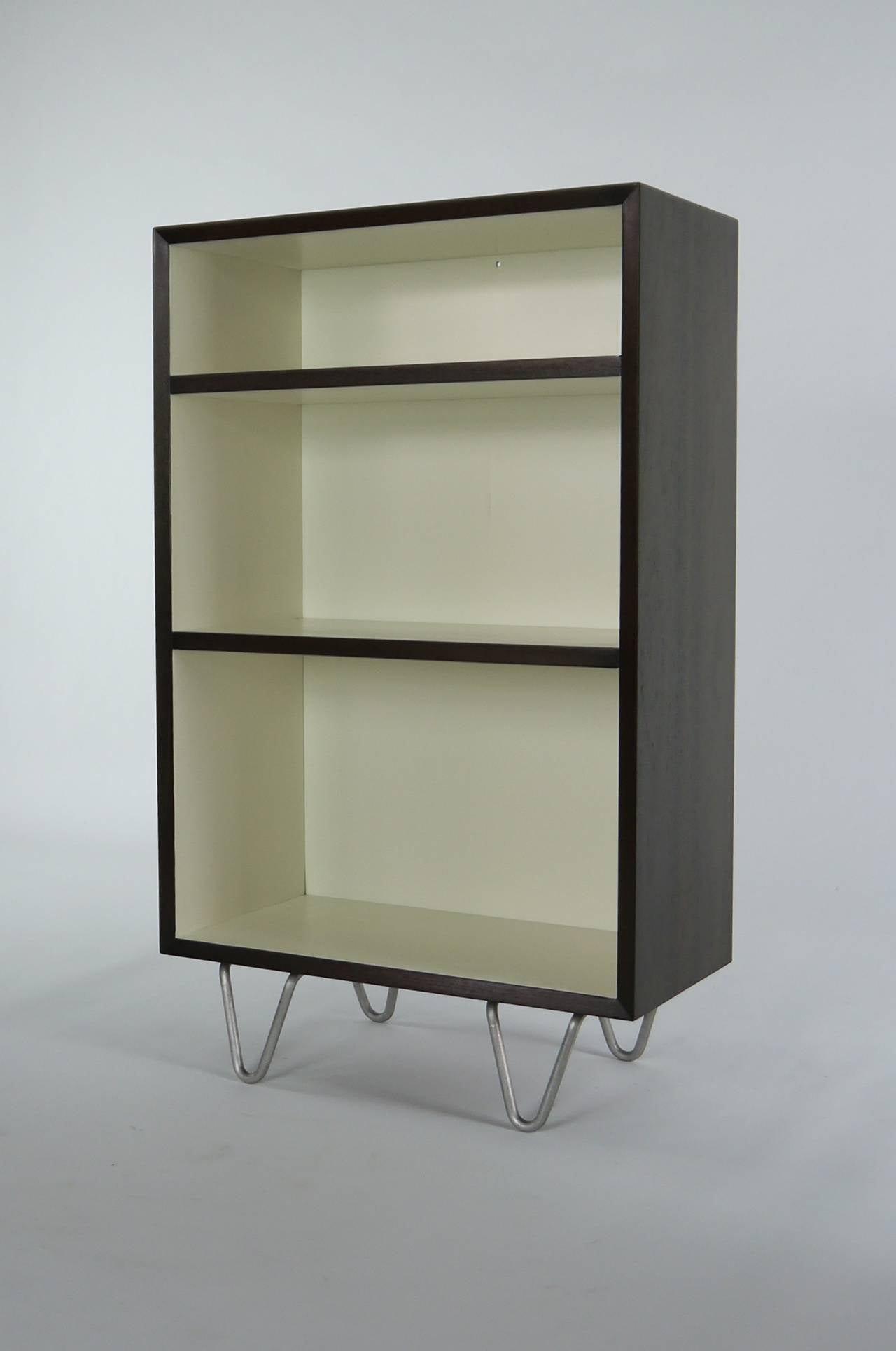 Bookcase on hairpin legs by George Nelson. Recently redone with a Cream lacquered interior and a Walnut exterior. A good solution for storage in small spaces. 39.5