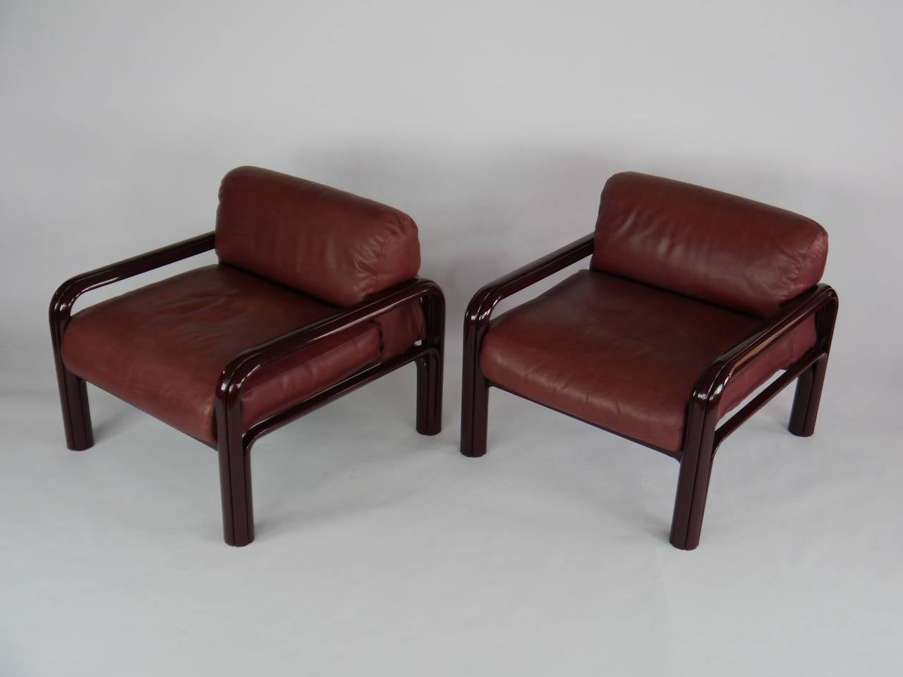 Pair of  lounge chairs designed by Gae Aulenti for Knoll (with label). Oxblood / red leather cushions and red frames. Very comfortable and very well made.