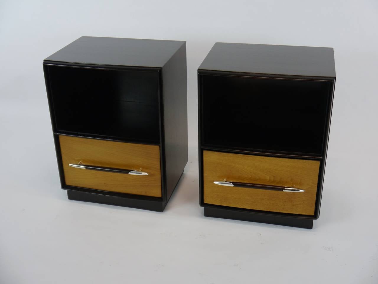 Tulip collection nightstands by T.H. Robsjohn-Gibbings for Widdicomb done in dark walnut and natural lacquer. The stave pulls have a gentle arch and are held on either end by silver plated 