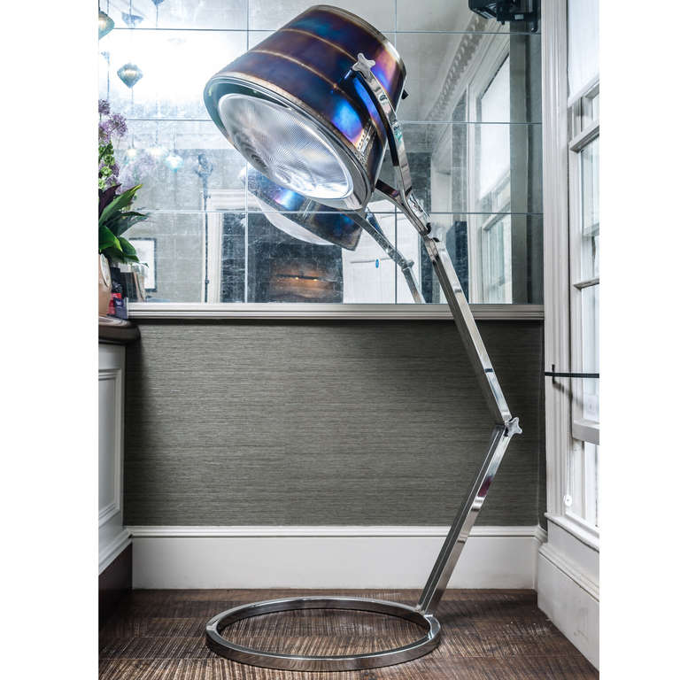 A 7 ft fully adjustable floor lamp with the head made from a BAe 146 engine exhaust. The stainless steel frame and fixtures have been designed and fabricated from the ground up to compliment the beautiful head. The glass is italian holophane.