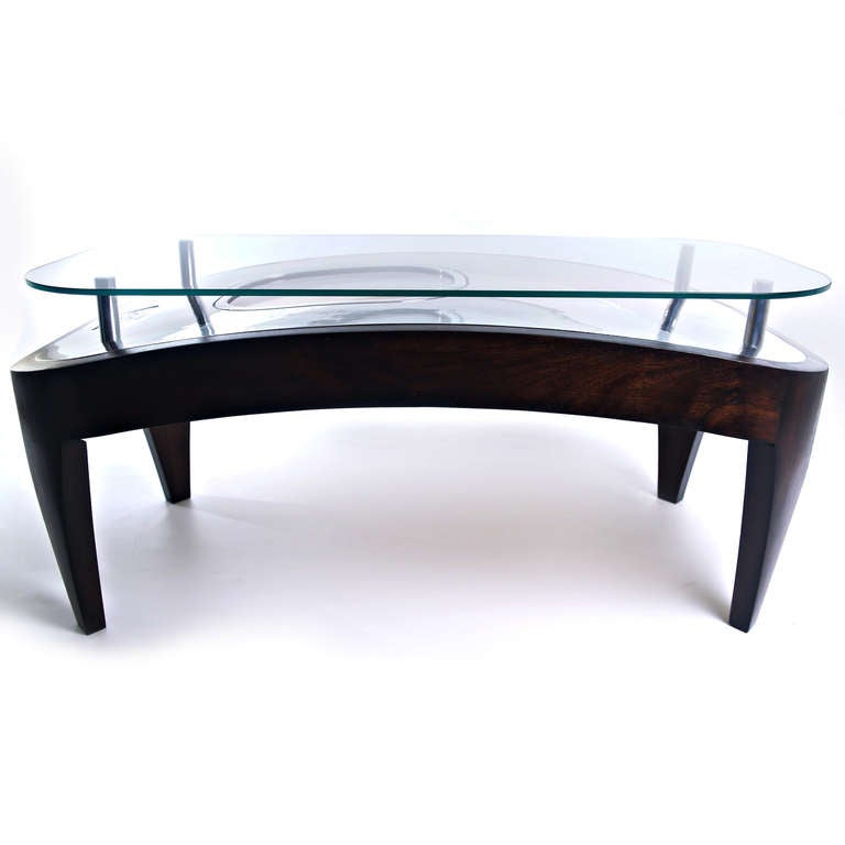 A modern, 21st century coffee table by designers Fallen Furniture.

This authentic Airbus A320 aircraft escape hatch has been entirely hand-polished to a mirror finish. The outer woodwork has been handcrafted out of sustainable, solid, black