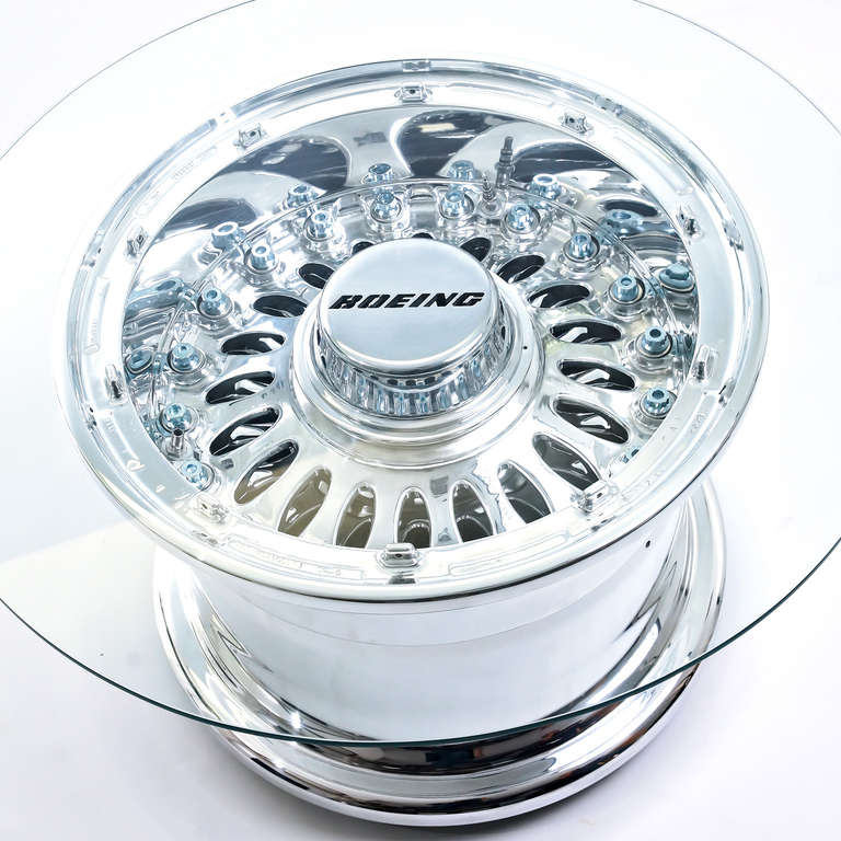 A modern, 21st century coffee table by designers Fallen Furniture.

This authentic Boeing 777 aircraft wheel has been entirely hand-polished to a mirror finish, the hubcap has been water-cut with the Boeing logo and a 40