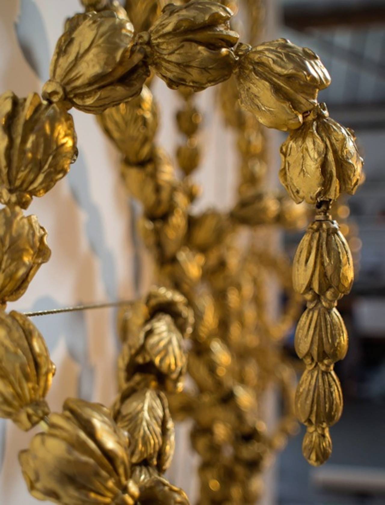 Resin, 23ct Gold Leaf and Brass.

Adams Vine is made up of 1000 cast and gilded husks strung on brass wire and trained up an interior wall in Classical Rococo style. The composition is versatile. It can be trained up a vertical interior wall,