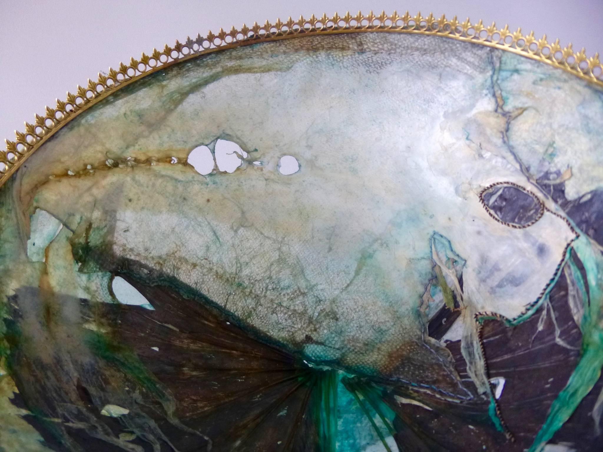 Exhibited at public gallery Saatchi London, February 2018 as part of the Transfiguration Exhibition.
The bowl is mounted on a brass ring stand to allow light to pass through the leather giving it an ethereal and ancient quality. The colour in fish